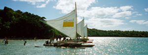 Traditional Kanak pirogues lined up along the northern end of Upi Bay, Île-des-Pins, New Caledonia